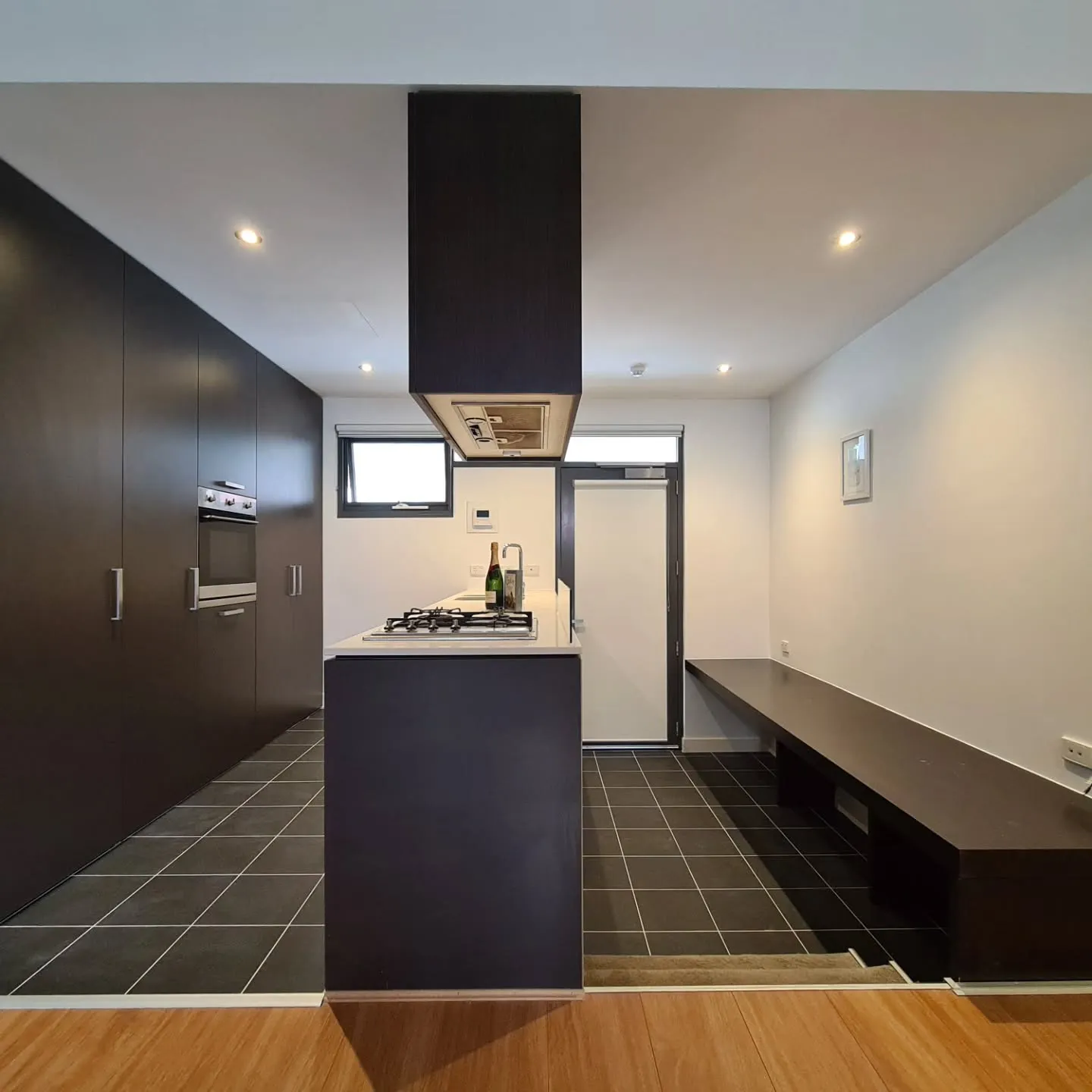 Modern kitchen renovation Docklands Melbourne, custom cabinetry and stone benchtop